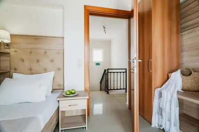 a bedroom with a bed and a table and a door at Villa Aretousa 1 in Agia Marina Nea Kydonias