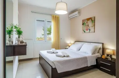 a bedroom with a bed with two towels on it at Villa Aretousa 1 in Agia Marina Nea Kydonias