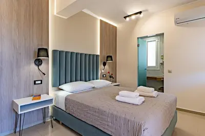 a bedroom with a bed with towels on it at Villa Aretousa 2 in Agia Marina Nea Kydonias
