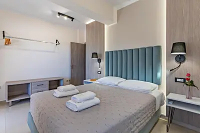 a bedroom with a large bed with towels on it at Villa Aretousa 2 in Agia Marina Nea Kydonias