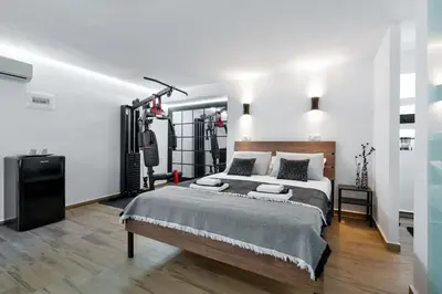 a bedroom with a large bed and a large mirror at Santy Villa - Gerani in Gerani Chanion