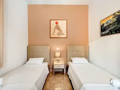 a room with two beds and a lamp in it at Villa in Kalamitsi near White Mountains in Kalamítsion Alexándrou