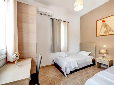 a bedroom with a bed and a desk and a table at Villa in Kalamitsi near White Mountains in Kalamítsion Alexándrou