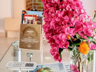a vase filled with pink flowers sitting on a table at Villa in Kalamitsi near White Mountains in Kalamítsion Alexándrou