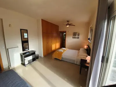 a hotel room with a bed and a tv at Argo Villa Kalives in Kalyves