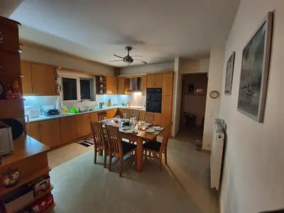 a kitchen with a table and chairs in a room at Argo Villa Kalives in Kalyves