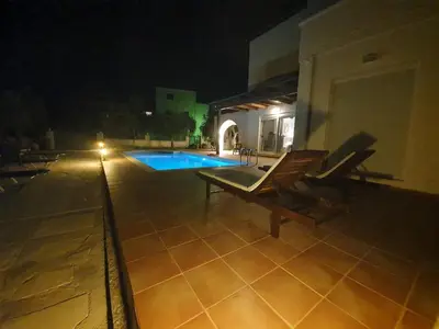 a view of a swimming pool at night at Argo Villa Kalives in Kalyves