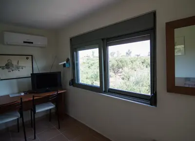 a room with a desk with a computer and a window at Ktima Nikolaos in Arónion
