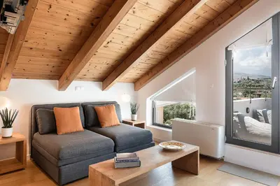 a living room with a couch and a table at Happy Villa in Kato Galatas