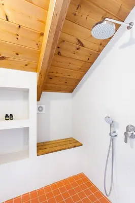 a bathroom with a shower with a wooden ceiling at Happy Villa in Kato Galatas