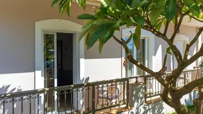 a front porch of a house with a tree at Vakakis-ME Apartments in Palaiochóra