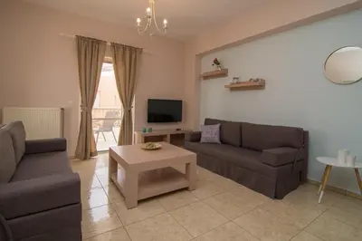 a living room with two couches and a table at Vakakis-ME Apartments in Palaiochóra