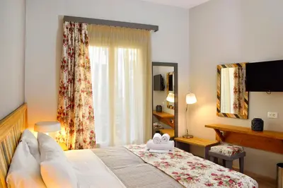 a bedroom with a large bed and a window at Elia Dorotheou in Chania Town