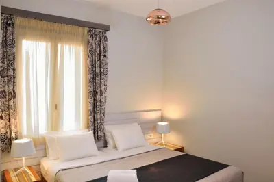 a bedroom with a bed and a large window at Elia Dorotheou in Chania Town