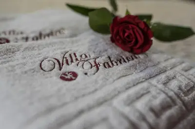 a red rose sitting on top of a piece of paper at Villa Fabrica in Thimiá