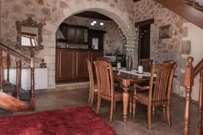 a kitchen with a table and chairs in a room at Villa Fabrica in Thimiá