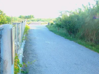 a road with a fence on the side of it at Sirens House in Tavronitis