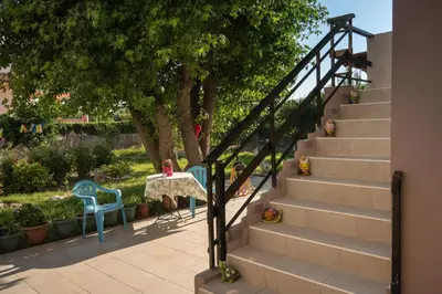 a set of stairs with two chairs and a table at Sirens House in Tavronitis