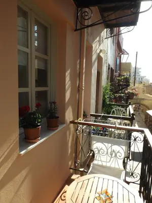 a balcony with benches and plants on a building at Fivos Pension in Chania Town