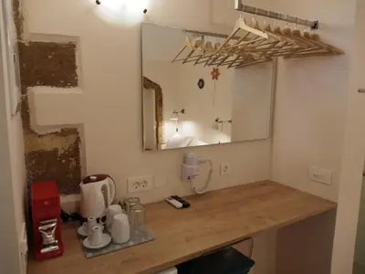 a bathroom with a wooden counter with a mirror at Fivos Pension in Chania Town