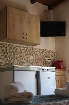 a kitchen with a white refrigerator and a sink at Fivos Pension in Chania Town