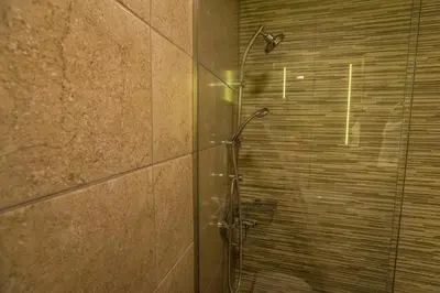 a shower with a glass door in a bathroom at 11City Rooms in Chania Town
