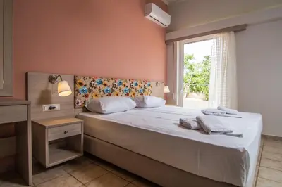 a bedroom with a large bed with a window at Grameno Apartments in Kountoura Selino