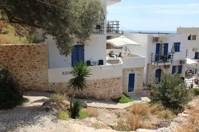 a building with a sign that reads roko at John Akroyiali in Loutro