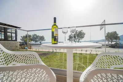 a table with a bottle of wine and two glasses at Blue Horizon in Palaiochóra