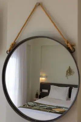 a mirror reflecting a bed in a bedroom at Blue Horizon in Palaiochóra