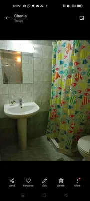 a bathroom with a sink and a shower curtain at Constantinos Budget Beds in Chania Town