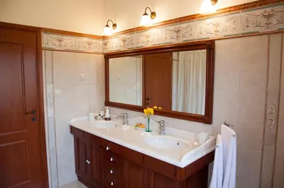 a bathroom with a sink and a mirror at Villa Allegra in Korfalónas
