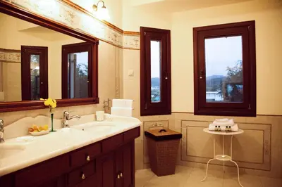 a bathroom with a sink and two windows at Villa Allegra in Korfalónas