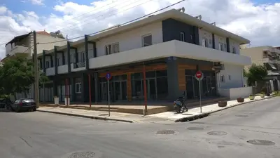 a building on the corner of a street with a motorcycle parked in front at Kleri Beloni Rooms in Chania Town