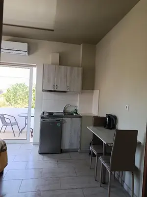 a kitchen with a table and a stove and a counter top at Kleri Beloni Rooms in Chania Town