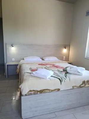 a bedroom with a large bed with towels on it at Kleri Beloni Rooms in Chania Town