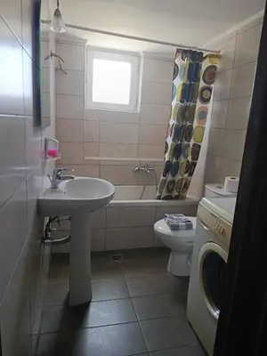 a bathroom with a sink and a tub and a toilet at Kleri Beloni Rooms in Chania Town