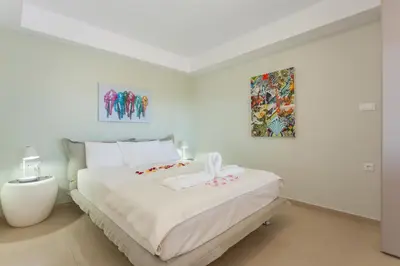 a white bedroom with a large white bed in it at Stefan's City Loft in Chania Town