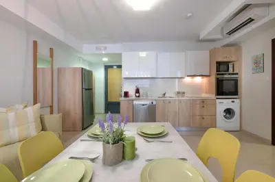 a kitchen and dining room with a table and chairs at Stefan's City Loft in Chania Town