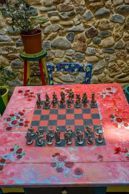 a chessboard on a table in front of a stone wall at Poco Loco Bed & Breakfast in Chania Town