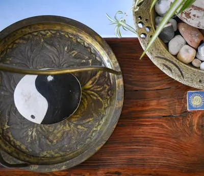 a bowl with a spoon on a wooden table at Poco Loco Bed & Breakfast in Chania Town