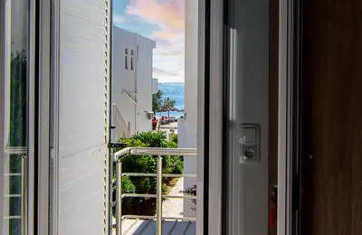 a view from a window of a balcony at Nicole Rooms in Palaiochóra