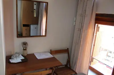 a dining room table with a mirror and a window at My Rooms in Chania Town