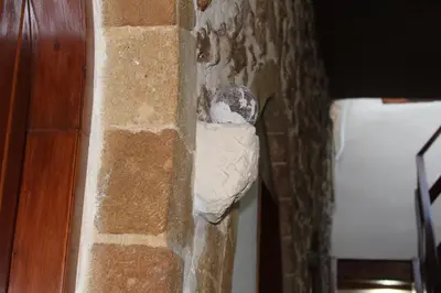 a brick wall with a paper hanging on it at My Rooms in Chania Town