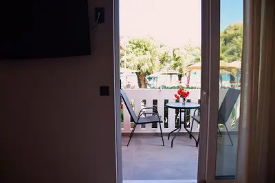 a view of a balcony with a table and chairs at Eden Beach Hotel in Agia Marina Nea Kydonias