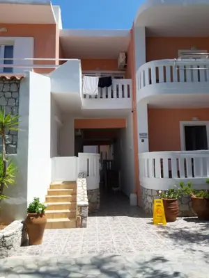 a view of a house with stairs and balconies at Eden Beach Hotel in Agia Marina Nea Kydonias