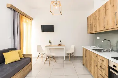 a kitchen with a couch and a table in a room at Castell Hotel in Kissamos