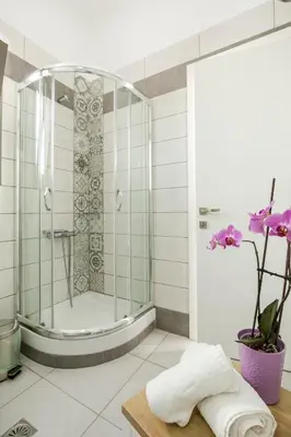 a shower in a bathroom with a glass shower stall at Castell Hotel in Kissamos
