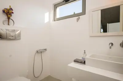 a white bathroom with a shower and a sink at Blue Sea Luxury Villa in Maleme