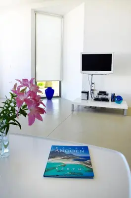 a living room with a table with a book on it at Blue Sea Luxury Villa in Maleme